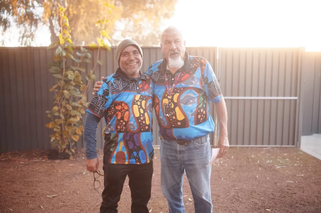 Two men hugging from behind